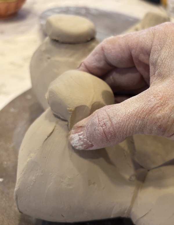 9 Once the desired shape is reached, add clay to close off bottom of each lobe.