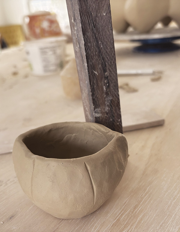 15 Use the wooden block’s side and edge to smooth and define opening shape.