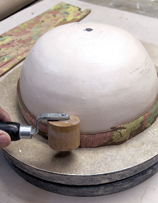 10 Use a small roller to compress the joined strip ends.