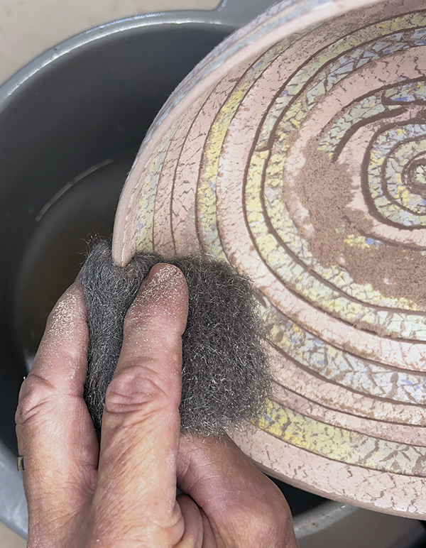 15 Smooth the greenware bowl with steel wool and bisque fire.