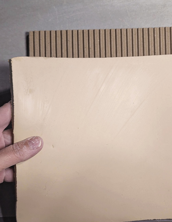 5 Lay a clay slab over the ribs and use a roller to press them together.