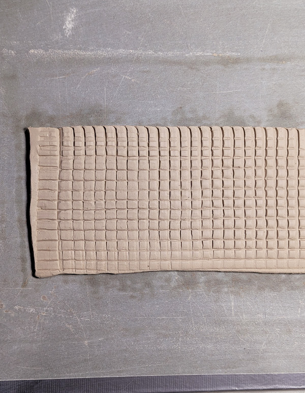 8 Criss-cross pattern made by turning the cardboard 90° and pressing again.