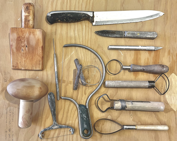 1 Tools for the job: paddles, kitchen knives, X-Acto knife, loop trimming tools, wire harp, cheese cutter, and needle tool.