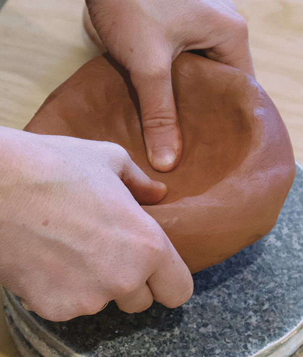 3 Pinch the ball into a thick bowl form with even walls.