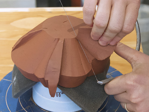 12 Mount the soft leather-hard basin upside down on foam over a chuck. Use a wire harp to contour the basin’s underside.