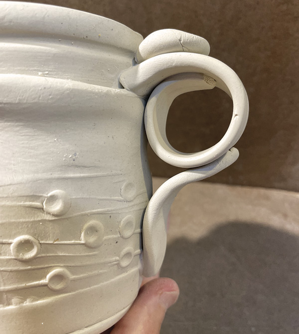 B6 Score and slip the finger rest on the underside of the circular piece.