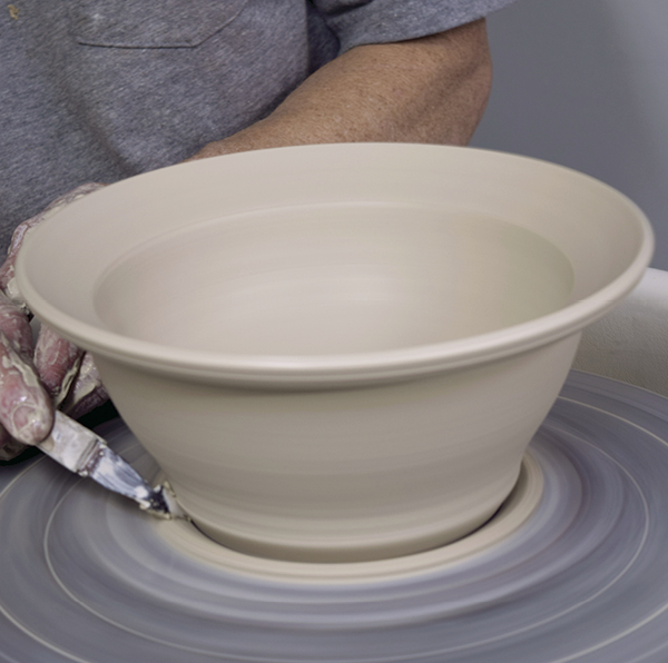 4 Trim away the excess clay from the base of the bowl.