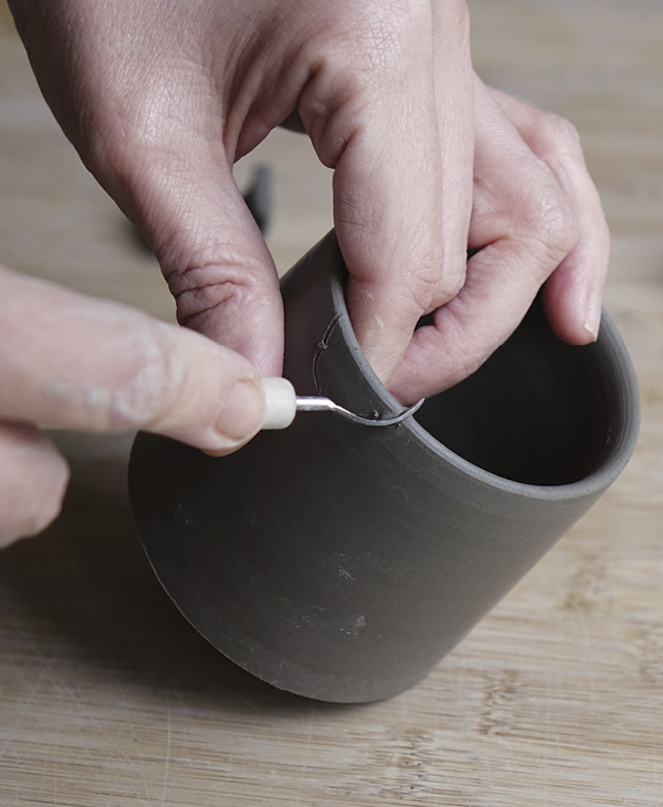 10 Cut the semicircle with a sharp tool, angling the wall slightly to accommodate a tilted spout.