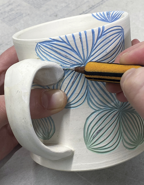 7 Tidy stray underglaze using a stylus or needle tool.