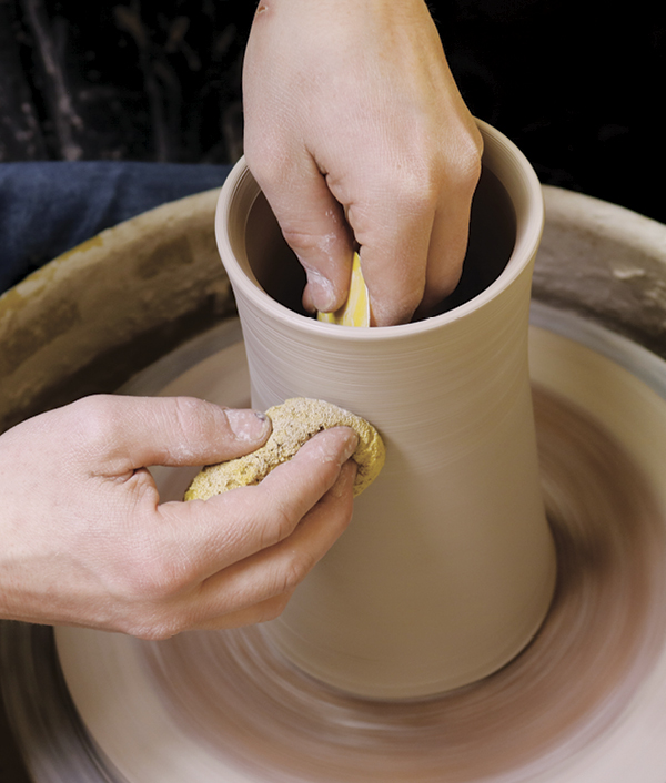 1 Compress the walls removing the throwing lines and excess slip from the surface of the pot.