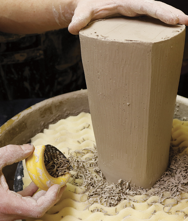 5 Using a Surform tool, define the edges of the pot working from the base to the lip on each side.