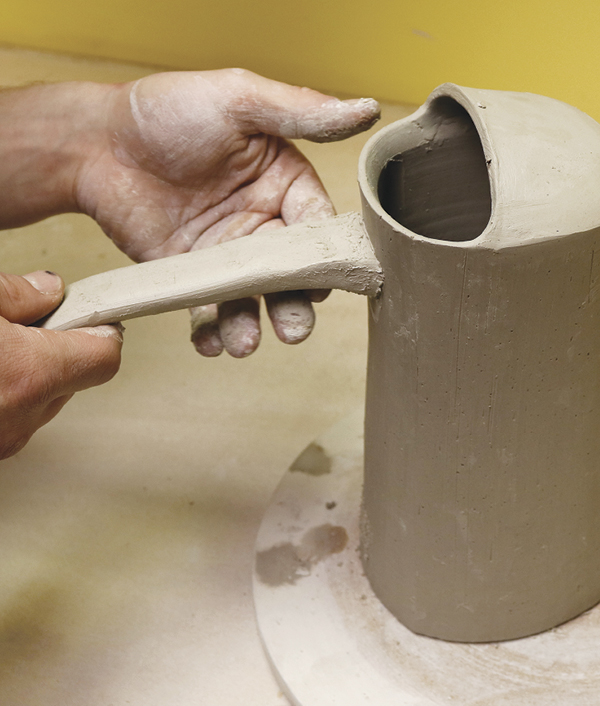 16 Cut the handle to 8 inches long, then cut the bottom at a 45° angle. Score, slip, and attach it to the body.