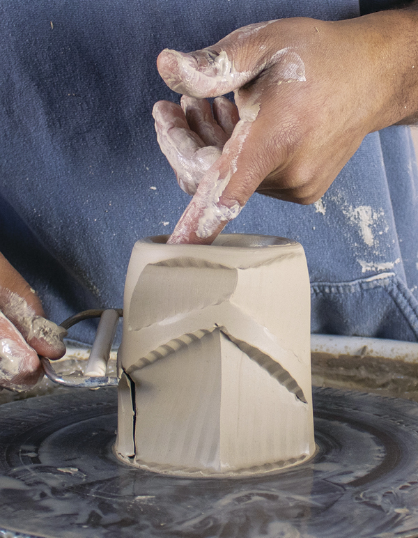 6 Facet the cup starting from the bottom to create a zigzagging pattern.