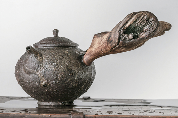 A finished kyusu with a found-wood handle.