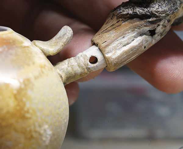 6 Check the handle for fit by sliding it over the hollow ceramic anchor. Adjust the handle if needed.