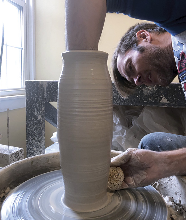 1 Wedge and center a stiff ball of clay, then throw the tallest, skinniest cylinder possible in three pulls.