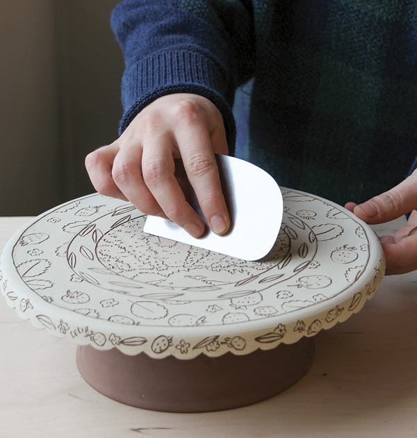 12 Gently clear away burrs from the sgraffito with the flat side of a metal rib.