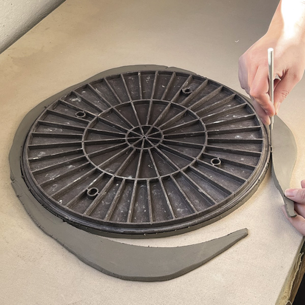 2 Use a 14-inch (35.6-cm) bat to cut the circle out of the slab.