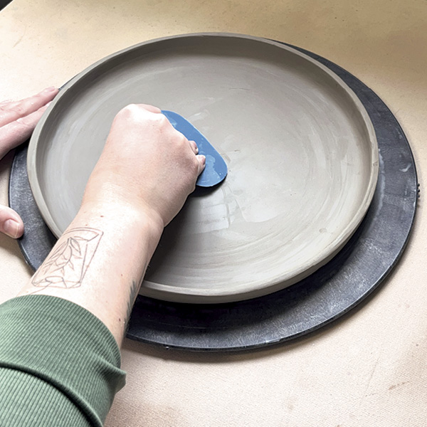 8 Gently flip the plate over and smooth the interior, again with a rubber rib.