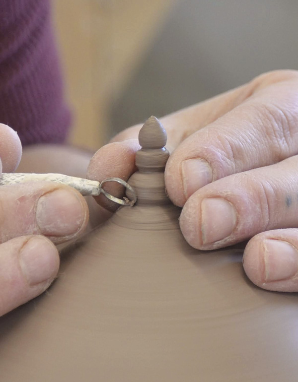 10 Using a small trimming tool, add detail to the point coming down from the base.