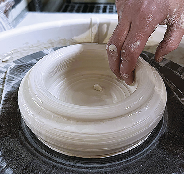 1 Center clay ball. When opening, use your fingers to create a wider base.