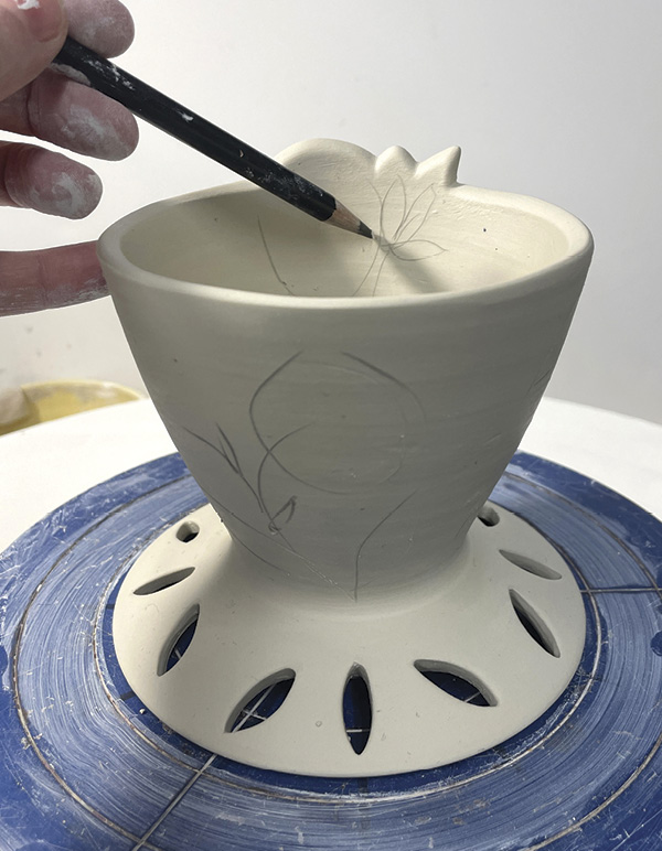 10 Draw the floral decoration with a pencil, then cut shallow lines through drawing.