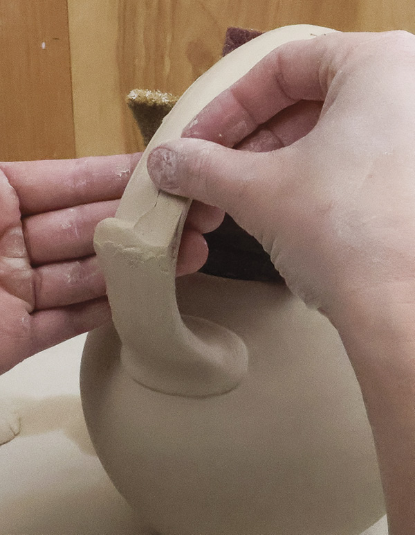 13 With identified pitch points, add lugs to the handle to create hand ledges.