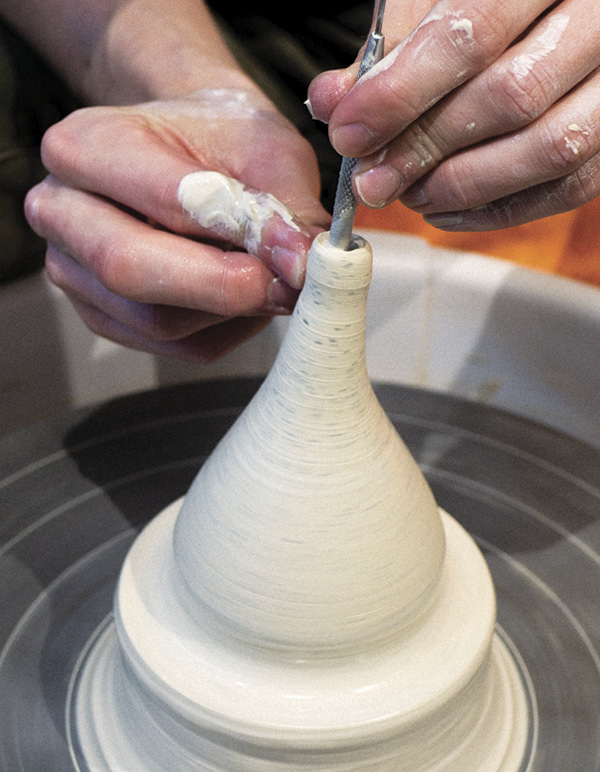 6 Collar in the upper half, then use a needle tool to throw and thin the spout.