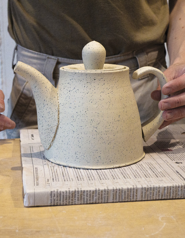 14 Attach the handle, thinner end up, making sure to align it with the spout.