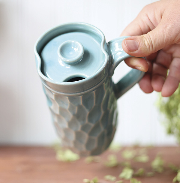 Dault Pottery's Faceted travel mug, 7 in. (17.8 cm) in height, light stoneware, robin’s egg blue glaze, 2024.