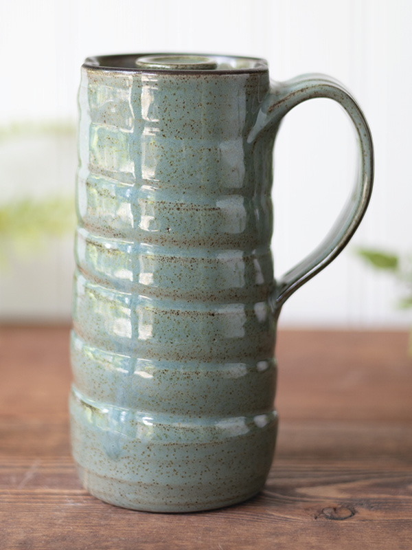 Dault Pottery's Travel mug, 61/2 in. (16.51 cm) in height, dark brown stoneware clay, robin’s egg blue glaze, 2024.
