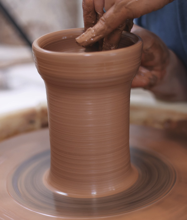 2 Center the 2-pound ball into a tall cylinder. Leave the upper rim thick to allow enough clay to create the gallery.