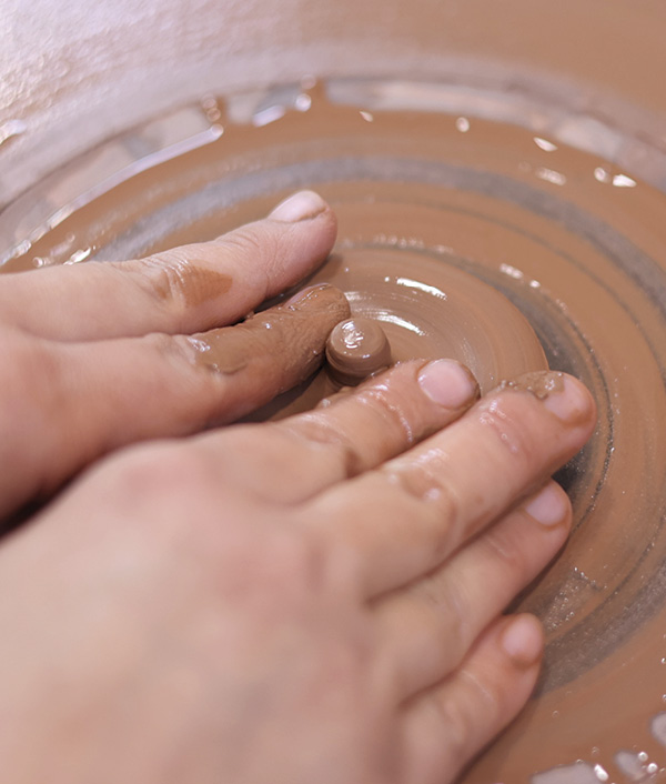 6 Throw the 4-ounce ball to make the lid. Use your index fingers to form a knob handle for the lid.