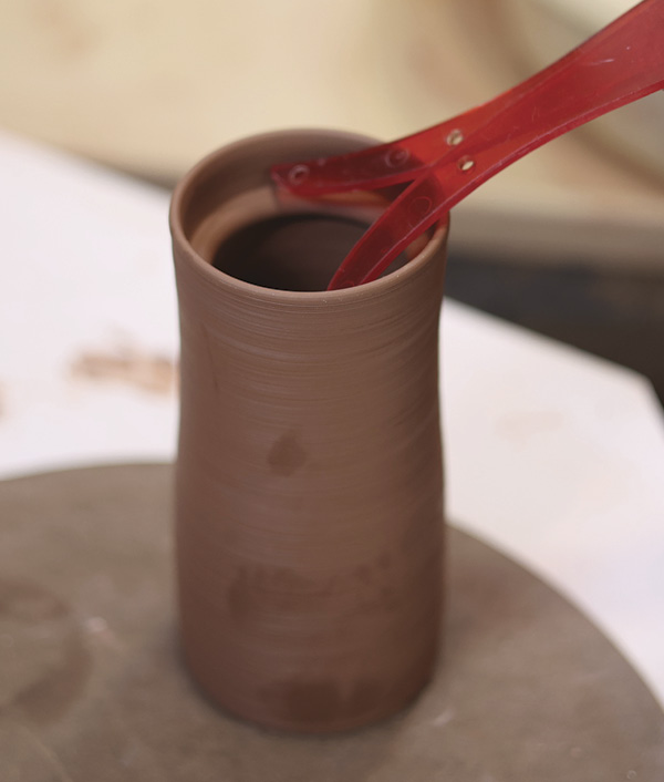 10 Using calipers, carefully measure the inside of the cylinder and trim the lid on the bat to fit.