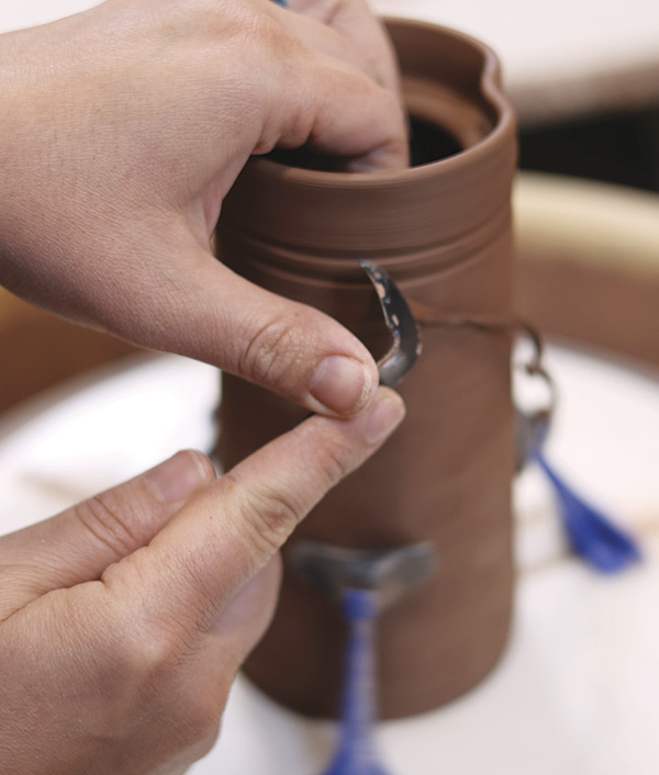 14 Trim any excess clay from the outer walls of the cylinder and from the base of the cylinder.