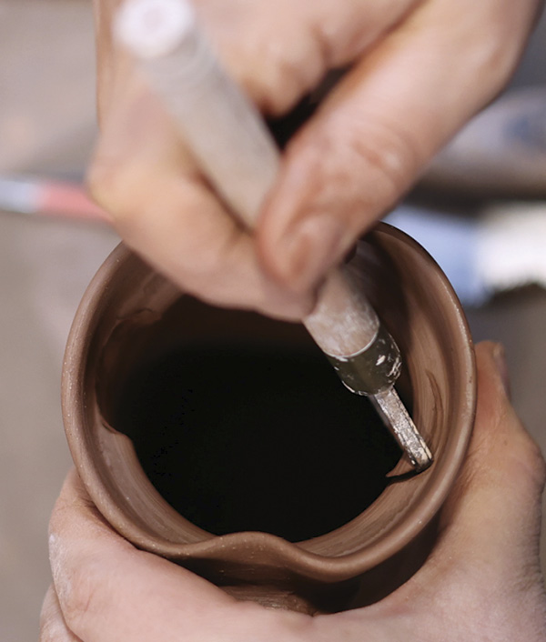 16 Use a round carving tool to cut two notches out of the gallery ledge opposite each other.