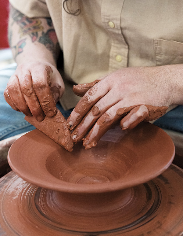 2 Flatten the upper half of the bowl to establish the flared edge.