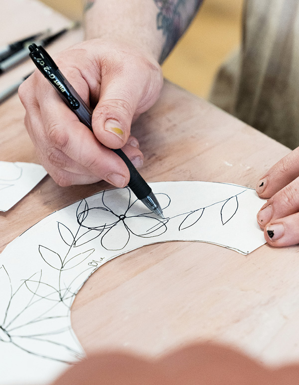 1 Draw patterns, designs, or florals on your half-circle, newspaper templates.