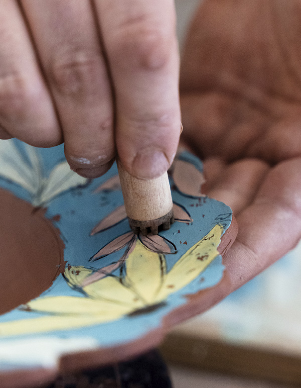 7 Add stamps. Using a supporting hand, gently but firmly press into the clay.