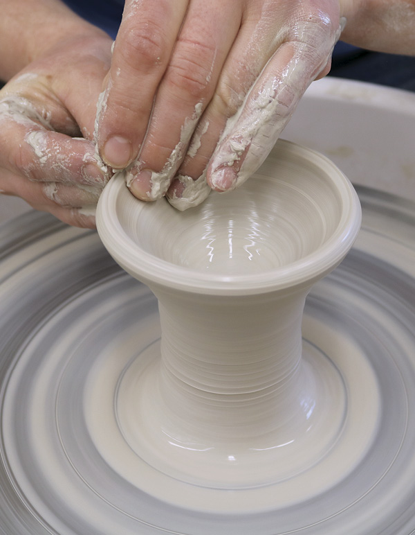 1 Center a ball of clay, collar it into a tall, solid cylinder.