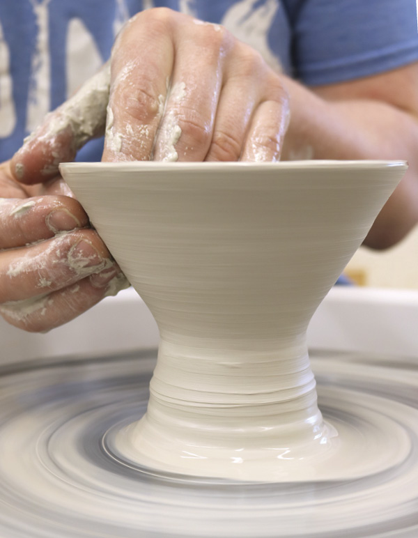 2 Open the clay and pull the wall out and up into a small V-shape.