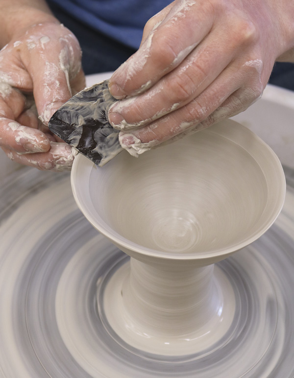 4 Use a stiff rib to bevel the rim to a 45° angle, keeping it as thin as possible.