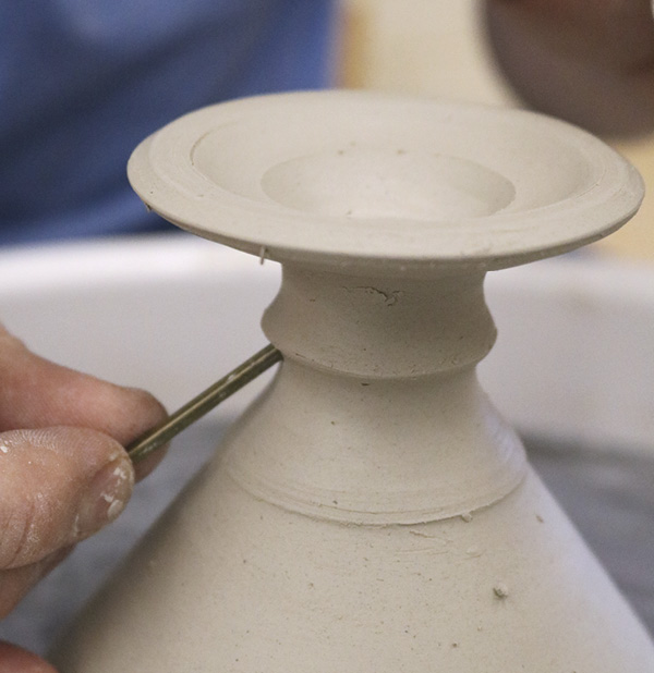 15 Use a needle tool to poke a hole into the curve on the stem to the interior base you carved out.