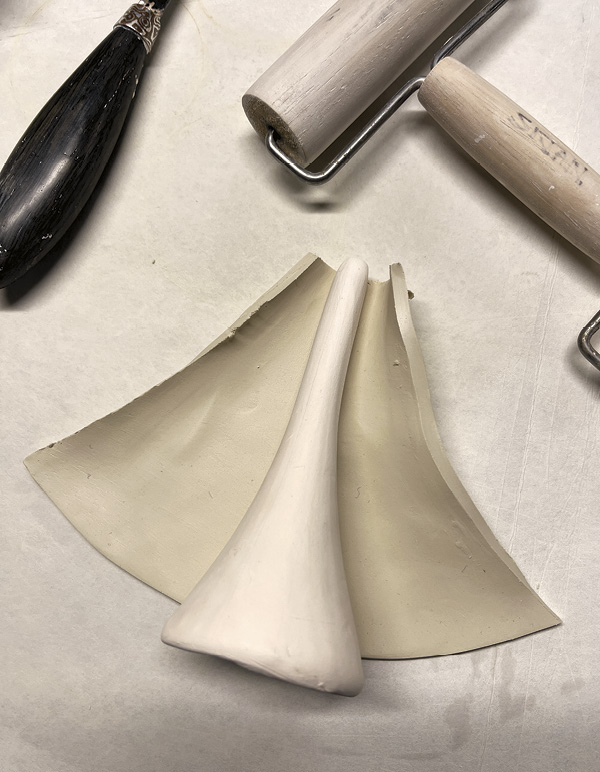 9 Pull a spout against a carrot-shaped bisque mold. Compress the seam.