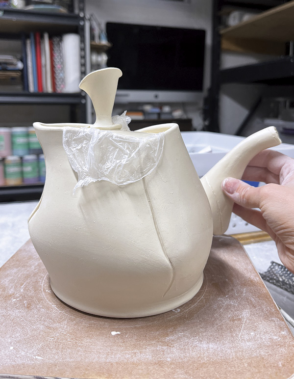 11 Trace the spout onto the pot, then shape the bottom before attaching.