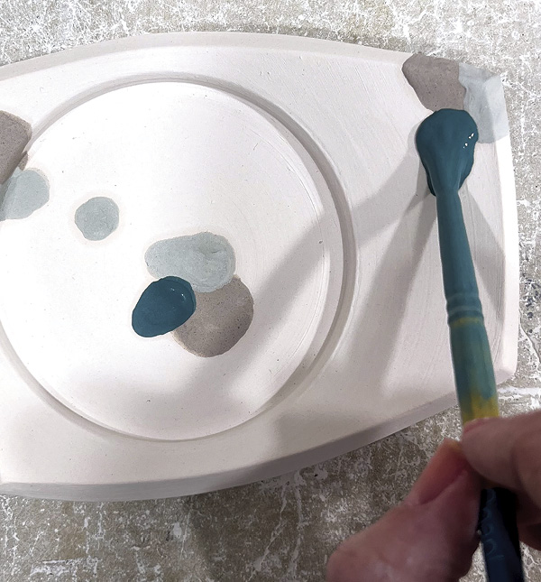9 Paint generous dollops of colored glaze on the bisque-fired pieces.