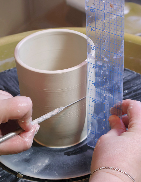 3 Throw a cylinder with a rounded floor. Mark where the flange will go.