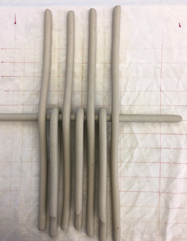 2 Fold every other vertical coil back on  to itself.