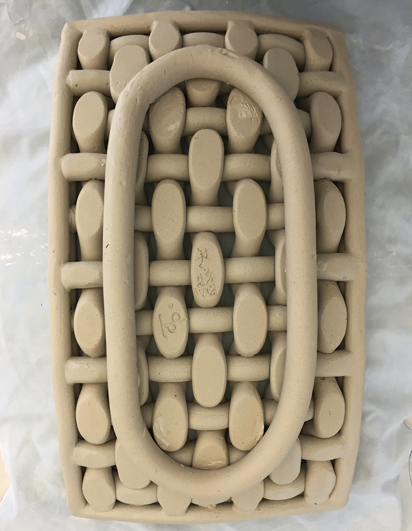 12 While the piece is still on the mold, attach another coil for a foot ring.
