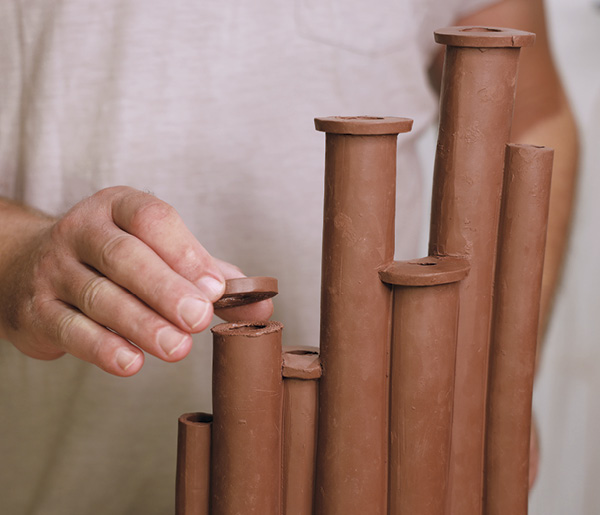 8 Slip, score, and attach a ring to the top of each cylinder to finish the rims.